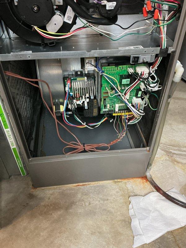 Completed cooling system tune-up on basement-mounted air conditioning unit with outdoor condenser at ground level. Performed comprehensive inspection of furnace cabinet interior, including motor assembly, control board, and electrical connections. Verified proper operation of condensate drainage system with PVC piping and confirmed all components functioning within normal parameters.
