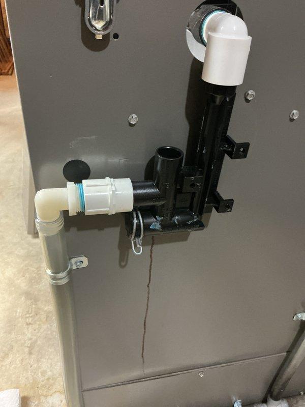Completed cooling system tune-up on basement-mounted air conditioning unit with outdoor condenser at ground level. Performed comprehensive inspection of furnace cabinet interior, including motor assembly, control board, and electrical connections. Verified proper operation of condensate drainage system with PVC piping and confirmed all components functioning within normal parameters.