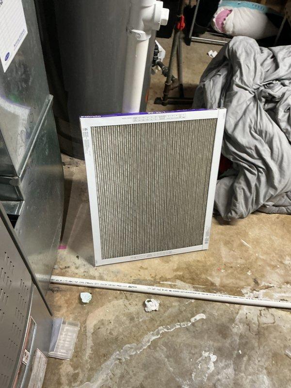 Performed comprehensive AC tune-up on outdoor condensing unit of unknown age. Inspected and cleaned heavily soiled evaporator coil which showed significant accumulation of dirt, dust, and debris in vertical patterns, indicating extended period without maintenance. Replaced dirty air filter showing visible discoloration and dust buildup. Completed standard maintenance procedures including inspection of electrical connections, refrigerant levels, and overall system operation. Unit returned to normal operating condition with improved airflow efficiency following coil cleaning and filter replacement.