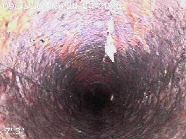Performed video camera inspection of sewer line in basement as follow-up to previous service call. Camera inspection revealed significant deterioration and buildup throughout the pipe interior, with extensive corrosion, mineral deposits, and discoloration visible on pipe walls at depths ranging from 7'3" to 8'10". Documentation photos captured showing compromised pipe condition with rough, uneven surfaces and substantial accumulation of debris and sediment coating the interior walls.
