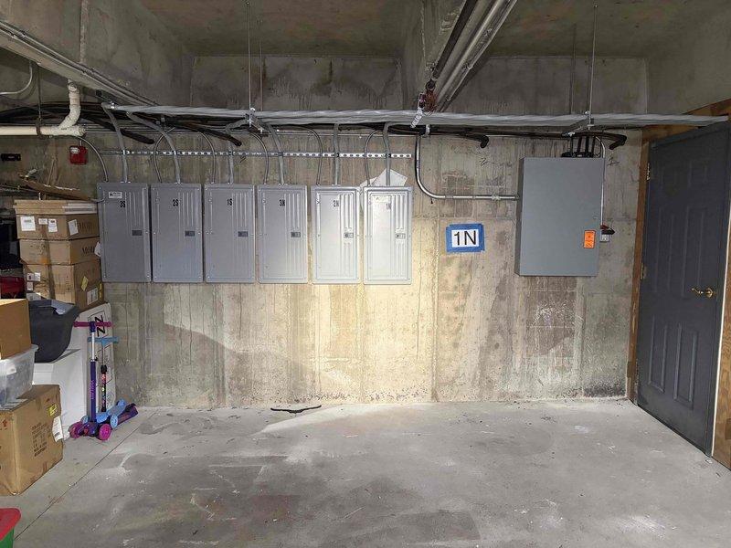 Conducted on-site assessment of commercial garage area to provide estimate for exhaust fan replacement. Evaluated existing 10-year-old exhaust fan unit mounted in garage space, documented electrical panel configuration and conduit routing for proper integration of new fan installation. Photographed existing conditions including electrical infrastructure, wall mounting location, and surrounding utility systems to ensure accurate bid preparation for single exhaust fan replacement unit.