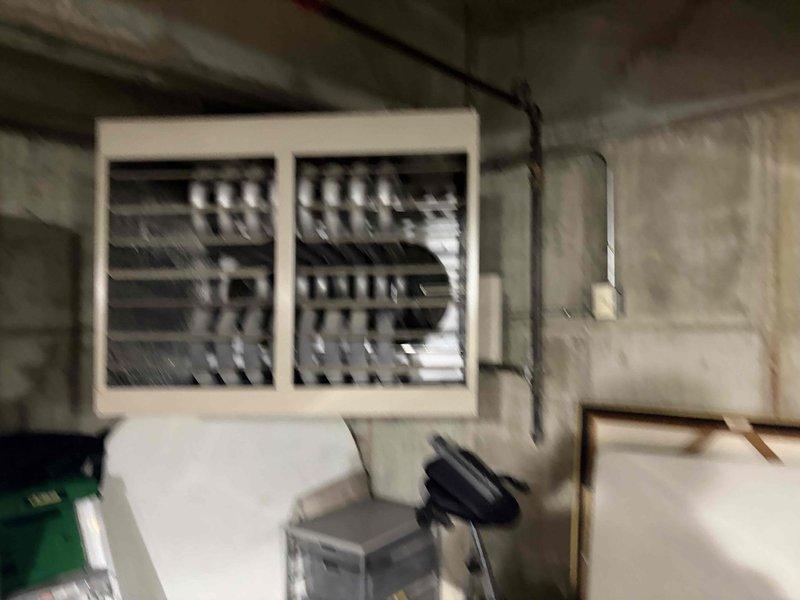 Conducted on-site assessment of commercial garage area to provide estimate for exhaust fan replacement. Evaluated existing 10-year-old exhaust fan unit mounted in garage space, documented electrical panel configuration and conduit routing for proper integration of new fan installation. Photographed existing conditions including electrical infrastructure, wall mounting location, and surrounding utility systems to ensure accurate bid preparation for single exhaust fan replacement unit.
