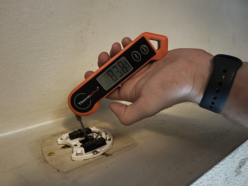 Responded to callback for inadequate cooling and persistent high humidity despite customer-installed dehumidifiers. Performed diagnostic testing on 10-year-old AC system that was running but unable to maintain temperature below 80 degrees with humidity at 87 percent. Measured supply air temperatures at register and evaporator coil to assess system performance. Findings indicate potential evaporator coil restriction or failure affecting both sensible and latent cooling capacity. Recommended evaluation of A-coil condition and possible replacement to restore proper dehumidification and cooling performance.