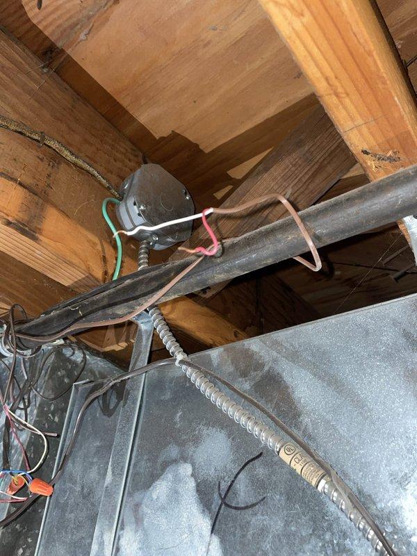 Responded to service call for 6-year-old thermostat displaying erratic temperature readings spiking into the 90s despite battery replacement. Inspected thermostat wiring at wall-mounted unit and traced connections to HVAC system in attic space. Identified loose or improperly seated wiring at thermostat terminal block causing intermittent signal communication between thermostat and system. Verified proper wire connections at R, C, W, and C terminals, ensuring secure contact at all connection points. Inspected junction box and wiring in attic to confirm proper voltage supply and eliminate potential issues with transformer or control circuit. Reinstalled thermostat, verified proper system operation, and confirmed temperature readings stabilized within normal parameters.
