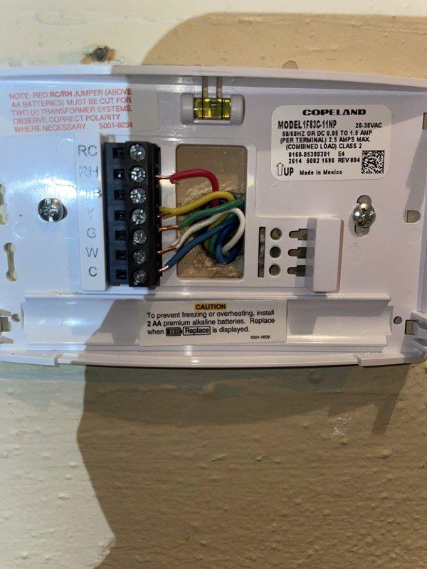 Responded to service call for 6-year-old thermostat displaying erratic temperature readings spiking into the 90s despite battery replacement. Inspected thermostat wiring at wall-mounted unit and traced connections to HVAC system in attic space. Identified loose or improperly seated wiring at thermostat terminal block causing intermittent signal communication between thermostat and system. Verified proper wire connections at R, C, W, and C terminals, ensuring secure contact at all connection points. Inspected junction box and wiring in attic to confirm proper voltage supply and eliminate potential issues with transformer or control circuit. Reinstalled thermostat, verified proper system operation, and confirmed temperature readings stabilized within normal parameters.