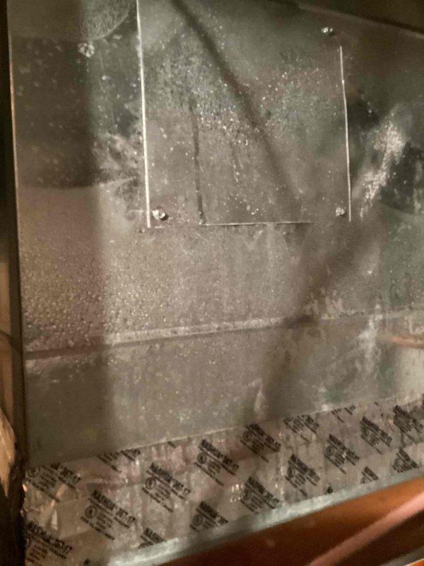 Responded to callback for excessive humidity levels (60-70%) in home with customer reporting concerns about humidifier malfunction. Upon inspection, found significant condensation and moisture accumulation throughout the ductwork and air handling unit in basement. Thermostat confirmed elevated indoor humidity reading of 62% with system set to 71°F. Inspected HVAC unit #10 and documented moisture conditions inside ductwork showing water droplets across metal surfaces and panels. Assessed humidifier operation and duct system for proper moisture control functionality.