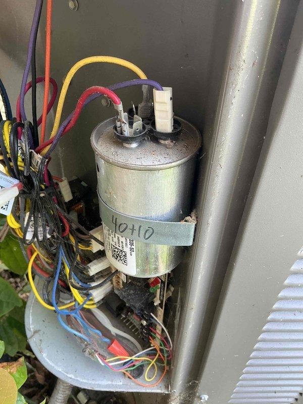 Responded to no cooling complaint on residential air conditioning system. Upon arrival, performed system diagnostics and identified failed dual-run capacitor as root cause of cooling failure. Capacitor tested out of specification range, preventing compressor and condenser fan motor from operating properly. Replaced defective capacitor with new OEM-equivalent dual-run capacitor rated at 40+10 MFD. Verified proper electrical connections, tested system operation, and confirmed unit returned to normal cooling function with appropriate temperature differential across evaporator coil.