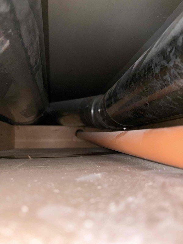 Responded to service call for suspected water leak from rooftop AC unit that was potentially misidentified as dryer leak during previous visit. Performed thorough inspection of six-year-old air conditioning system, including visual examination of condensate drain lines, drain pan, and ductwork accessible through attic space. Inspected flexible metal ductwork runs and surrounding ceiling areas for evidence of moisture intrusion or water damage. System operational check confirmed unit cooling properly with no immediate signs of active leakage at time of inspection. Documented conditions with photos of ductwork and accessible components in confined attic space for reference.
