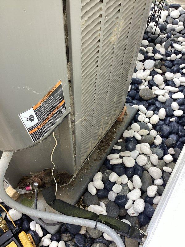 Completed comprehensive cooling system tune-up on 9-year-old residential air conditioning unit. Performed standard maintenance protocol including inspection of condenser coils, refrigerant levels, electrical connections, and overall system operation. Unit is currently positioned on decorative river rock landscaping with adequate clearance; discussed options with customer for improving condenser pad stability and leveling, as unit is currently supported on temporary blocking rather than proper concrete pad foundation.