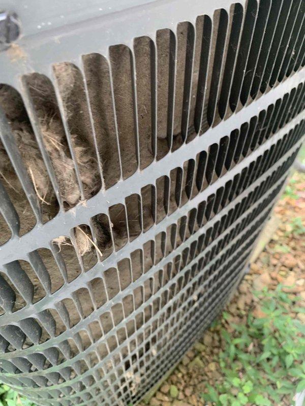 Performed comprehensive HVAC tune-up and maintenance on air conditioning system and furnace with no reported operational issues. Conducted thorough inspection of outdoor condenser unit, which revealed significant accumulation of dirt, dust, and debris on finned coil assembly and protective grille, impacting system efficiency. Cleaned condenser coils and external components to restore proper airflow and heat transfer capability, removing heavy buildup of particulate matter from aluminum fins and louvered protective cover.