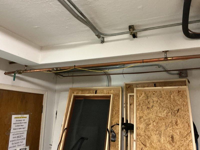 Responded to building drain blockage affecting office AC unit condensate drainage. Accessed mechanical room and utility area to locate main drain cleanout for commercial building. Assessed drainage system including copper piping and condensate lines serving HVAC equipment. Cleared obstruction in main building drain to restore proper flow and prevent water backup that was impacting office air conditioning unit operation. Verified drainage system functionality upon completion.