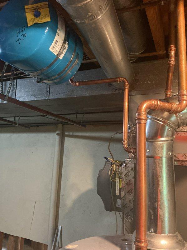 Installed 75-gallon gas tall water heater in basement mechanical room with proper copper piping connections to supply and distribution lines. Equipment was set up per manufacturer specifications with all required safety labels visible, expansion tank secured with metal strapping, and connections to existing HVAC system verified. Permit obtained and installation financed through service financing program.