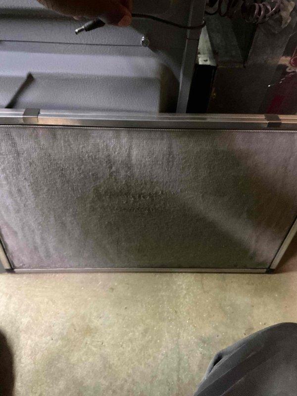 Responded to no cooling complaint on residential HVAC system over 10 years old located in side yard. Upon arrival, found air handler with heavily soiled return air filter restricting airflow. Performed system diagnostics using digital manifold gauges, revealing operating pressures of 133.5 psi low side and 317.7 psi high side with temperature readings of 46.4°F and 99.9°F. Evaluated superheat and subcooling values to assess refrigerant charge and system performance. Identified restricted airflow due to clogged filter as primary cause of inadequate cooling and system's inability to maintain setpoint temperature. Documented equipment condition with photos showing significant dust accumulation on filter media and current system pressures. Advised customer of findings and recommended filter replacement to restore proper airflow and system efficiency.