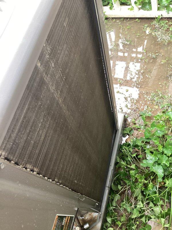 Performed comprehensive cooling system tune-up on outdoor condenser unit located in backyard. Unit exhibited significant dirt and debris accumulation on air filter/intake panel and condenser coils, which were heavily soiled and restricting proper airflow. Cleaned condenser coils and replaced/cleaned air filter to restore optimal system efficiency and heat transfer capability.