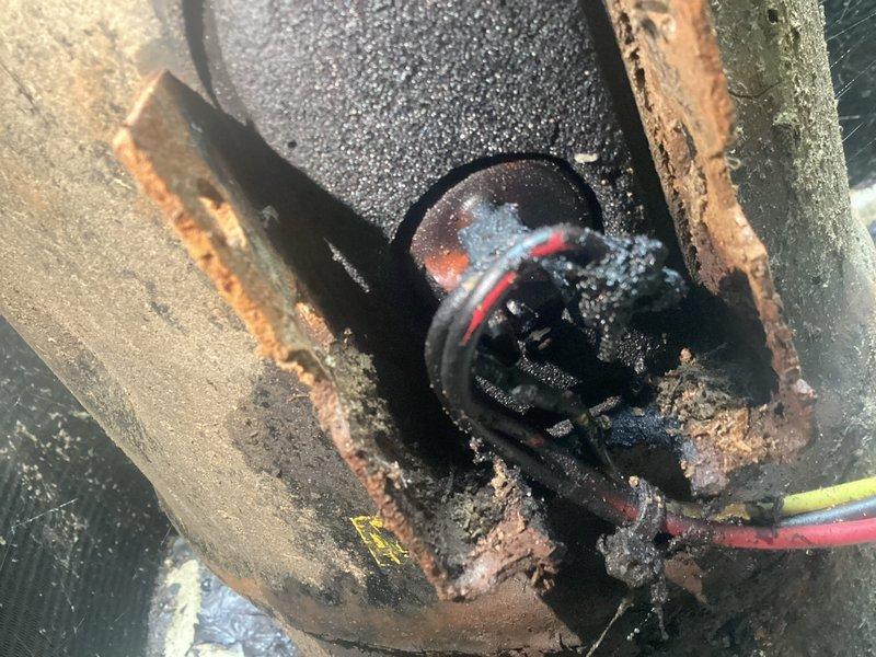 Responded to no cooling complaint on aging HVAC system over 10 years old. Upon inspection, discovered failed capacitor with severely corroded electrical connections and deteriorated wiring in outdoor condensing unit. Capacitor housing showed extensive rust and oxidation, with surrounding components exhibiting moisture damage and environmental degradation. Replaced defective capacitor, secured all electrical connections, and verified proper voltage readings. System restored to operational status with normal cooling function confirmed before departure.