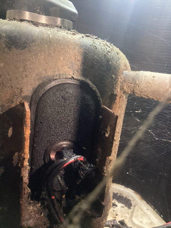 Responded to no cooling complaint on aging HVAC system over 10 years old. Upon inspection, discovered failed capacitor with severely corroded electrical connections and deteriorated wiring in outdoor condensing unit. Capacitor housing showed extensive rust and oxidation, with surrounding components exhibiting moisture damage and environmental degradation. Replaced defective capacitor, secured all electrical connections, and verified proper voltage readings. System restored to operational status with normal cooling function confirmed before departure.