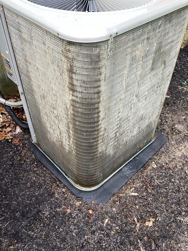 Performed comprehensive Supertune maintenance on residential HVAC system including outdoor AC condenser unit and indoor air handler/furnace. Inspected control board, wiring connections, and blower assembly inside air handler—all components found secure and operational. Exterior condenser unit showed significant weathering and vertical staining on coil fins; cleaned debris from unit and surrounding area. Addressed noise concern by inspecting both systems; verified proper operation of fan motors and mechanical components. Both AC and heating systems tested and confirmed operational following tune-up procedures.