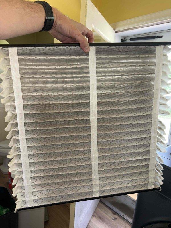Completed comprehensive cooling system tune-up on single outdoor AC unit. Inspected and replaced heavily soiled air filter showing significant particulate accumulation. Condenser coils exhibited substantial debris buildup with clogged fins and organic matter collected at base; cleaned coils to restore proper airflow and heat transfer efficiency. Inspected refrigerant lines and connections for proper insulation and secure fittings. System returned to optimal operating condition.