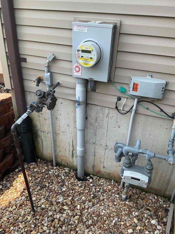 Completed comprehensive electrical estimate for residential standby generator installation. Assessed existing utility infrastructure including electrical meter, gas meter, and associated service connections to determine requirements for generator tie-in. Documented current electrical service configuration, gas supply system, and available space for generator placement on concrete pad with existing river rock landscaping. Evaluated conduit routing options, transfer switch location, and necessary upgrades to accommodate automatic standby generator system integration with existing residential utilities.