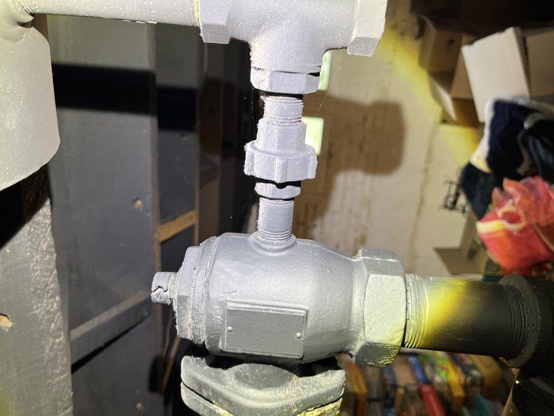 Responded to service call for non-operational boiler system located in basement. Upon inspection, identified issues with valve assembly and pipe connections in the heating system. Performed diagnostic evaluation of plumbing components, including examination of insulated piping, valve fittings, and brass pipe sections. Documented existing conditions of mechanical system components with photographic evidence showing valve assembly, pipe insulation, and connection points requiring attention for proper boiler operation.