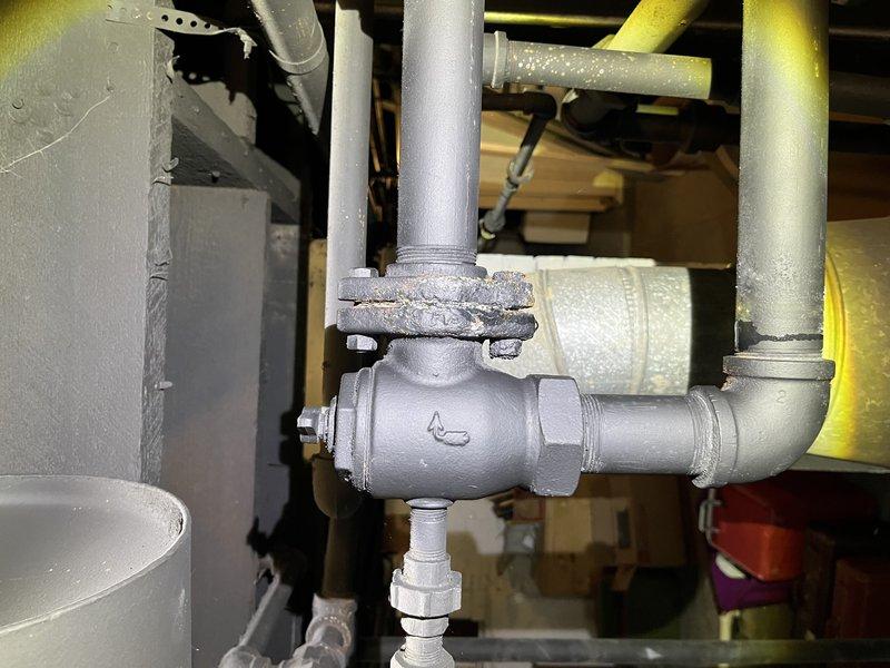Responded to service call for non-operational boiler system located in basement. Upon inspection, identified issues with valve assembly and pipe connections in the heating system. Performed diagnostic evaluation of plumbing components, including examination of insulated piping, valve fittings, and brass pipe sections. Documented existing conditions of mechanical system components with photographic evidence showing valve assembly, pipe insulation, and connection points requiring attention for proper boiler operation.
