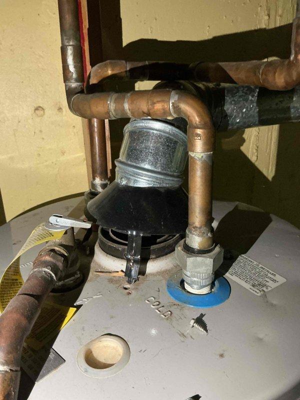 Installed 40-gallon short gas water heater in basement utility area. Connected hot and cold water supply lines with copper piping, installed pressure relief valve, and attached stainless steel flue venting to exhaust system. Applied required plumbing identification sticker and ensured all connections met code requirements under permit 26PLU-15924. Unit tested and operational upon completion.