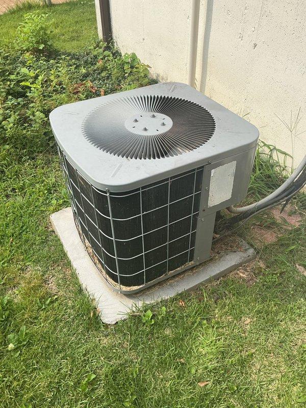 Responded to no cooling complaint on 23-year-old ICP system where indoor unit was blowing warm air while outdoor condenser was discharging cold air, affecting entire home. Upon arrival, performed diagnostic evaluation of both indoor air handler located in basement mechanical room and outdoor condensing unit positioned on concrete pad adjacent to building exterior. Identified reversed refrigerant flow condition indicating compressor valve failure or refrigerant system malfunction in aging equipment. Given the advanced age of the system and nature of the failure, provided assessment and recommendations for repair versus replacement options. Documented equipment condition through photographs of outdoor condenser unit and indoor air handler installation for reference and records.