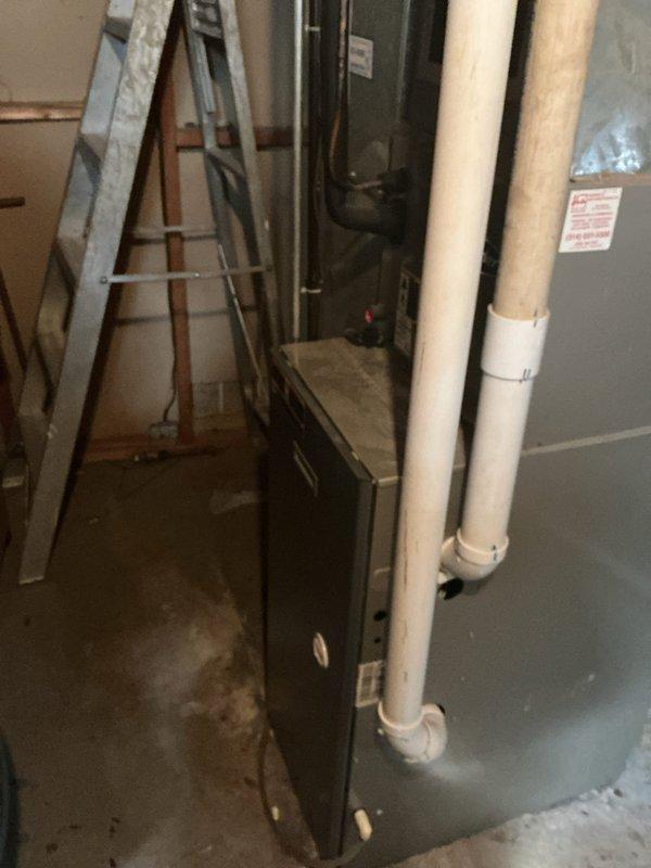 Responded to no cooling complaint on 23-year-old ICP system where indoor unit was blowing warm air while outdoor condenser was discharging cold air, affecting entire home. Upon arrival, performed diagnostic evaluation of both indoor air handler located in basement mechanical room and outdoor condensing unit positioned on concrete pad adjacent to building exterior. Identified reversed refrigerant flow condition indicating compressor valve failure or refrigerant system malfunction in aging equipment. Given the advanced age of the system and nature of the failure, provided assessment and recommendations for repair versus replacement options. Documented equipment condition through photographs of outdoor condenser unit and indoor air handler installation for reference and records.