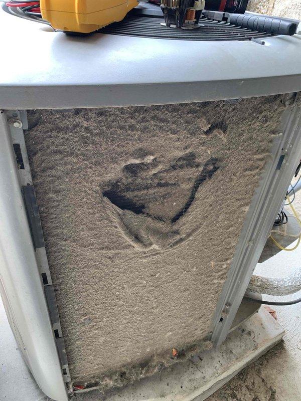 Responded to no-cool complaint on residential HVAC system. Upon inspection, discovered severely clogged evaporator coil with heavy dust and debris accumulation restricting airflow and preventing proper heat exchange. Removed access panel, documented extent of contamination, and inspected electrical connections and wiring which appeared intact. System failure attributed to lack of regular maintenance resulting in complete airflow blockage at the indoor coil assembly.