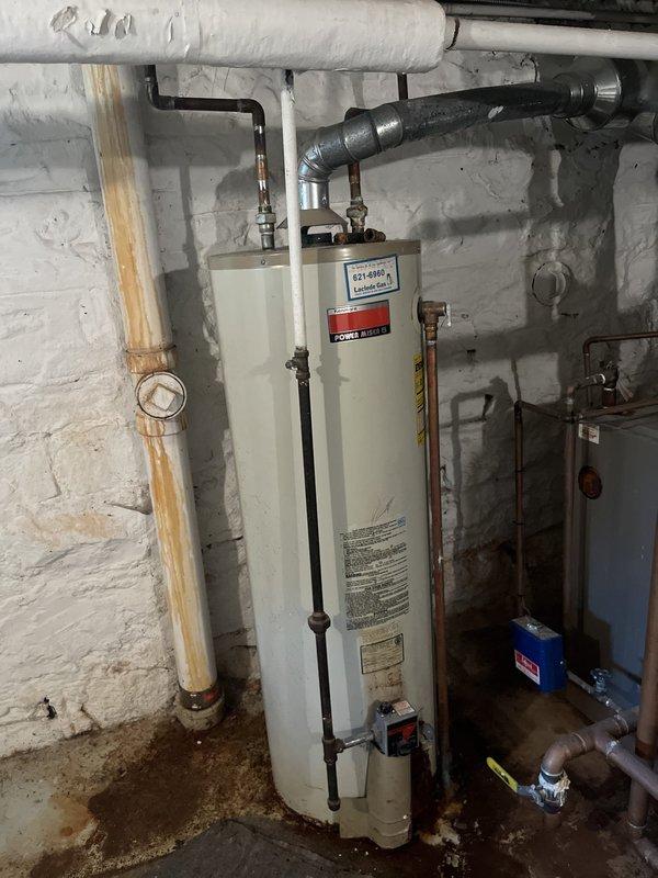Replaced non-functional 40+ year old gas water heater with new 40-gallon State Proline gas water heater in basement utility area. Removed existing unit showing signs of age and failure, installed replacement tank with proper gas line connections, water supply lines, and venting system per manufacturer specifications and local code requirements. Tested all connections for leaks, verified proper combustion and venting operation, and ensured system functionality upon completion.