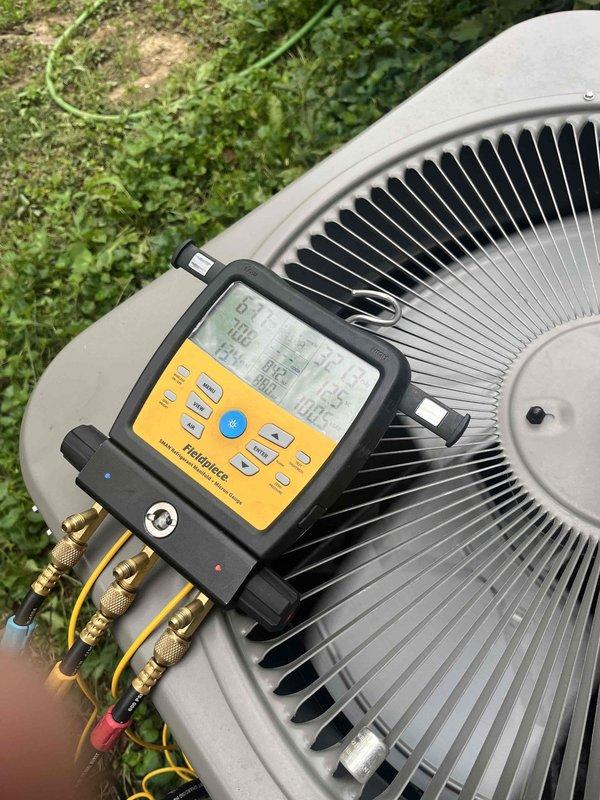 Responded to no cooling complaint on ground-level hallway unit. Upon arrival, connected manifold gauge set to outdoor condenser unit to assess refrigerant pressures and system performance. Diagnosed system issue and advised customer to shut off air conditioning system immediately to prevent further damage while leaving fan in run mode to maintain air circulation. Inspected indoor components including what appears to be the air handler or associated equipment with pressure relief valve and copper refrigerant lines showing age-related oxidation on brass fittings.