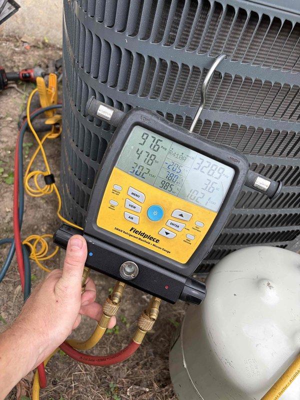 Responded to no cooling call for 4-year-old Goodman GSX140241LE condenser unit affecting entire residence. Upon arrival, performed diagnostic evaluation using digital manifold gauges to measure system pressures and temperatures. Readings indicated abnormal operating parameters with discharge temperature at 97.5°F and suction temperature at 47.8°F. Connected refrigerant recovery equipment and service hoses to access ports on outdoor unit. Verified electrical specifications on unit nameplate showing 208-230V single-phase system with proper circuit breaker sizing. Completed system diagnostics and corrective measures to restore cooling operation to manufacturer specifications.
