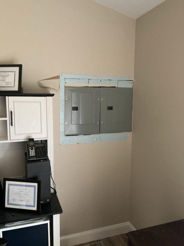 Completed installation of four sub-panels in residential property, mounting panels on interior walls with proper spacing and clearances per code requirements. Performed drywall modifications and patching around panel installations, with finish painting to integrate electrical infrastructure into living space.