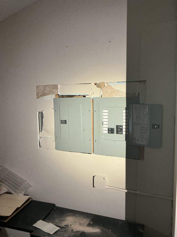 Completed installation of four sub-panels in residential property, mounting panels on interior walls with proper spacing and clearances per code requirements. Performed drywall modifications and patching around panel installations, with finish painting to integrate electrical infrastructure into living space.
