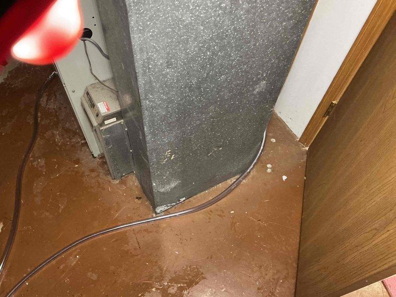 Responded to service call for air conditioning unit leaking water in basement. Upon inspection, found condensate drain line clogged, causing water to back up and leak from the air handler. Cleared blockage from condensate line, verified proper drainage, and tested system operation to ensure issue was resolved.