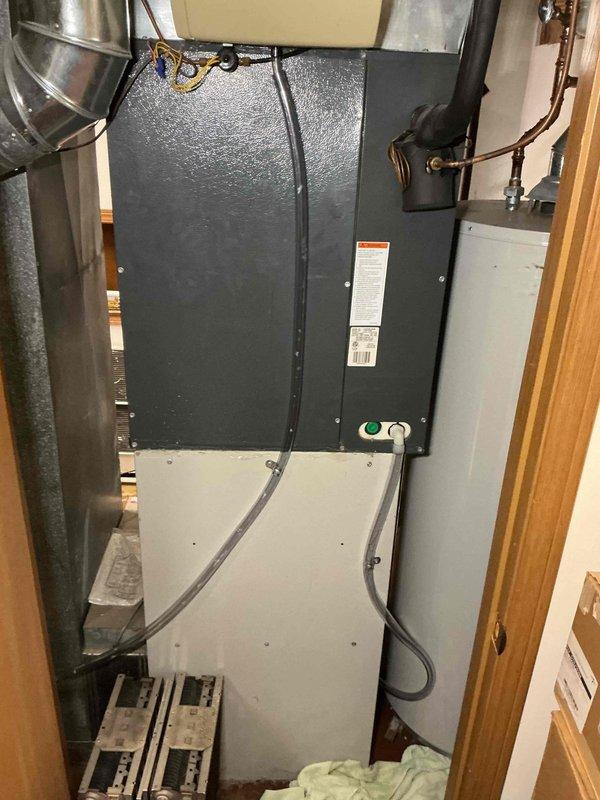 Responded to service call for air conditioning unit leaking water in basement. Upon inspection, found condensate drain line clogged, causing water to back up and leak from the air handler. Cleared blockage from condensate line, verified proper drainage, and tested system operation to ensure issue was resolved.