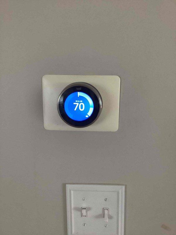 Responded to no cooling call where system was blowing warm air and producing low humming noise. Upon arrival, found Nest thermostat set to cooling mode at 70°F but unit not providing adequate cooling. Inspected outdoor condenser unit and identified low refrigerant charge as primary issue. Advised customer to keep system off until repairs could be completed to prevent compressor damage from continued operation under low refrigerant conditions.