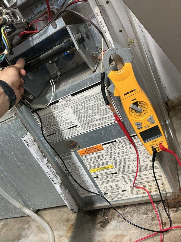 Responded to no heat call on residential HVAC system over 10 years old located in backyard. Upon arrival, performed tune-up inspection on cooling system and diagnosed furnace failure to ignite. Used Fieldpiece diagnostic meter to test electrical components and verify proper voltage and amperage readings. Identified faulty ignition system preventing furnace operation. Replaced defective ignitor assembly and verified proper flame sensor operation. Inspected air filter condition and checked airflow through pleated filter media. Tested system startup sequence and confirmed furnace now cycles properly with successful ignition and heat output. System restored to full operational status.