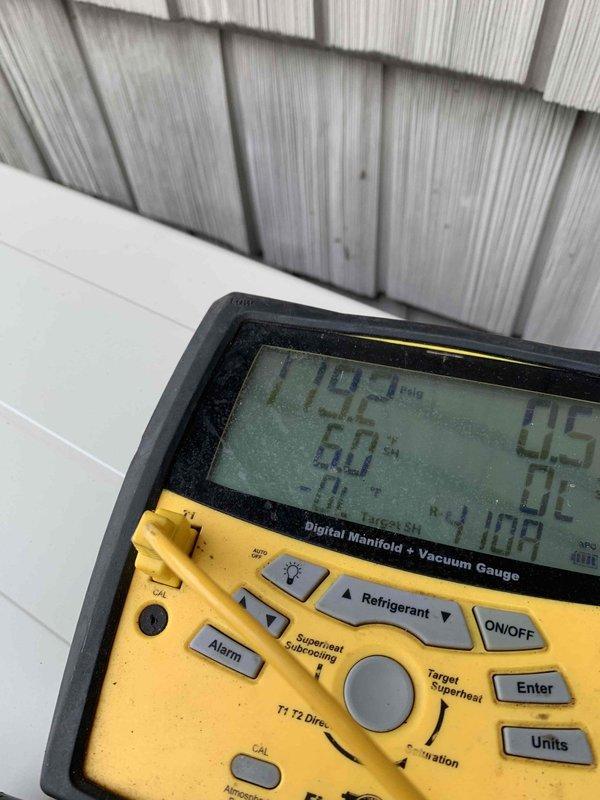 Responded to service call for mini split system in upstairs bedroom with reported issue of green light flashing but no cool air output. Upon arrival, performed diagnostic evaluation of outdoor condensing unit and measured system pressures and vacuum levels using digital manifold gauge. System showed abnormal readings indicating refrigerant circuit issues, with vacuum reading of -70 and improper superheat conditions at 60%, confirming unit's inability to provide cooling despite receiving power signal from indoor head unit.