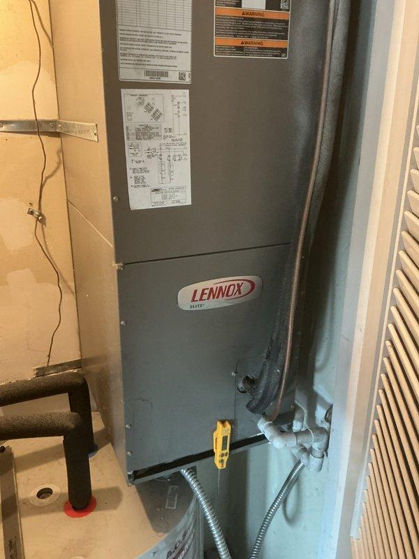 Responded to a no-cooling complaint on a Lennox HVAC system with inadequate temperature differential and abnormal humming noise from the outdoor condenser unit. Upon inspection, found the outdoor unit's condenser coil heavily soiled with dirt and debris accumulation, particularly on the lower sections of the mesh grille, which was restricting airflow and reducing system efficiency. The indoor air handler showed signs of requiring maintenance service. Performed thorough cleaning of the condenser coil to restore proper airflow through the heat exchanger. Addressed the humming noise issue at the outdoor unit and verified proper fan operation. Following service, tested system performance and confirmed cooling differential returned to acceptable range between 16-22 degrees. System restored to normal operating condition with improved airflow and proper refrigerant heat exchange.
