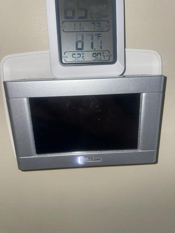 Responded to no-power condition at thermostat with AC system not functioning. Upon arrival, inspected wall-mounted thermostat display showing irregular readings and checked power supply to unit. Evaluated outdoor condensing unit U10 in backyard, noting dirty evaporator coil with significant dust and debris accumulation on fins requiring cleaning. Provided customer with repair options to restore system operation.