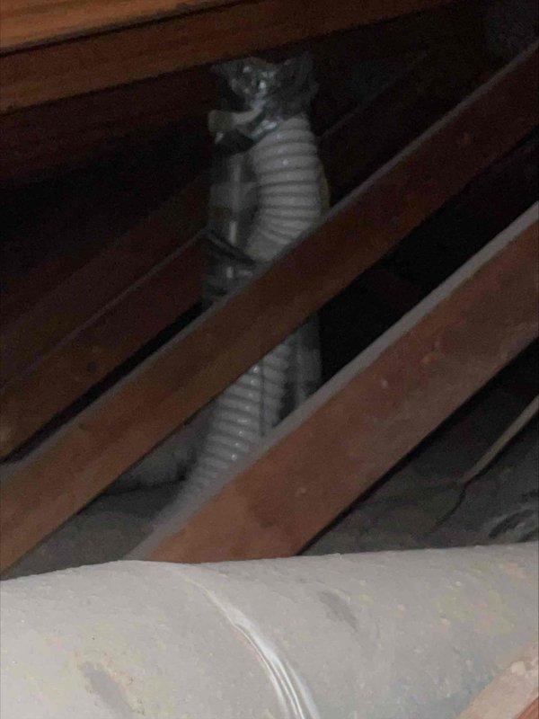 Responded to water leak complaint affecting lower level unit from upper HVAC system. Upon investigation, accessed attic space and located source of water intrusion traveling down condensate drain line from upper air handler. Created ceiling access point to inspect drain routing and confirmed blockage causing overflow condition. Cleared obstruction from primary drain line, verified proper drainage flow, and tested system operation to ensure leak was resolved. Documented attic ductwork configuration and drain line pathway for service records.
