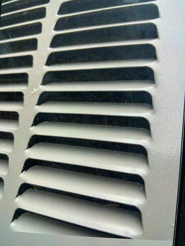 Responded to service call for reported popping noise from one of two AC units upon startup. Arrived on-site and performed diagnostic inspection of Unit 10 located at side of property. Conducted visual examination of system components and documented condition of air handler return grille assembly. Inspected ventilation grille for proper mounting, structural integrity, and potential sources of mechanical noise during system cycling. Grille showed normal operational wear with minor dust accumulation on horizontal louvers. Evaluated ductwork connections, mounting hardware, and frame assembly for loose fasteners or contact points that could generate popping sounds during thermal expansion or compressor engagement. Photographed affected components for service documentation. System requires further evaluation of startup sequence and potential component repairs to resolve reported noise concern.