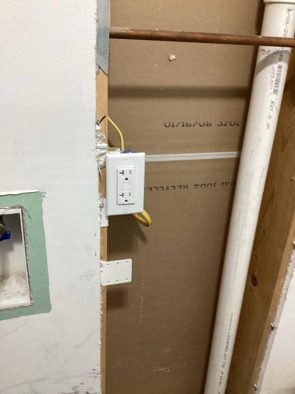 Installed dedicated 240V outlets for washer and dryer in laundry area using 12-4 Romex wiring. Work included mounting GFCI-protected receptacles in wall cavities with proper grounding, routing electrical cable through framing studs, and ensuring compliance with code requirements for appliance circuits in areas with plumbing infrastructure present.