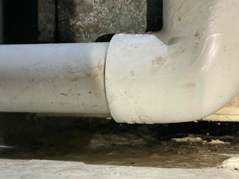 Responded to callback for ongoing water leak at furnace location. Upon inspection, identified failed condensate drain coupling and deteriorated O-ring seal causing water discharge beneath unit. Removed defective PVC connector and gasket, cleaned pipe connections, and installed replacement components. Verified proper drainage flow and confirmed leak was resolved with no further water accumulation observed at time of departure.