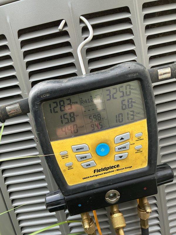 Responded to service call for 10-year-old AC unit experiencing unusual buzzing noise and excessive vibration affecting the entire structure. Performed comprehensive diagnostic evaluation using refrigerant manifold gauge to assess system pressures and temperatures, with readings indicating 458 PSI low side and 598 PSI high side. Conducted electrical testing with clamp meter on control components and wiring connections to identify potential electrical faults contributing to vibration and noise issues. Documented system conditions and component status for repair recommendations.