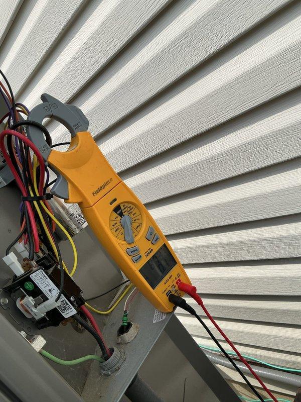 Responded to service call for 10-year-old AC unit experiencing unusual buzzing noise and excessive vibration affecting the entire structure. Performed comprehensive diagnostic evaluation using refrigerant manifold gauge to assess system pressures and temperatures, with readings indicating 458 PSI low side and 598 PSI high side. Conducted electrical testing with clamp meter on control components and wiring connections to identify potential electrical faults contributing to vibration and noise issues. Documented system conditions and component status for repair recommendations.