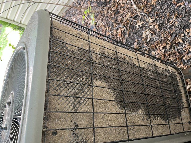 Responded to no-cool call on 10-year-old upstairs AC system. Upon arrival, found outdoor condenser unit with heavily soiled mesh guard and significant debris accumulation restricting airflow. Performed thorough cleaning of condenser coils and protective mesh guard, removed accumulated dirt, dust, and organic debris from unit exterior and surrounding area. Verified proper airflow restoration, checked refrigerant pressures, and tested system operation. Unit returned to normal cooling function with adequate airflow through condenser. Recommended regular maintenance to prevent future airflow restrictions.