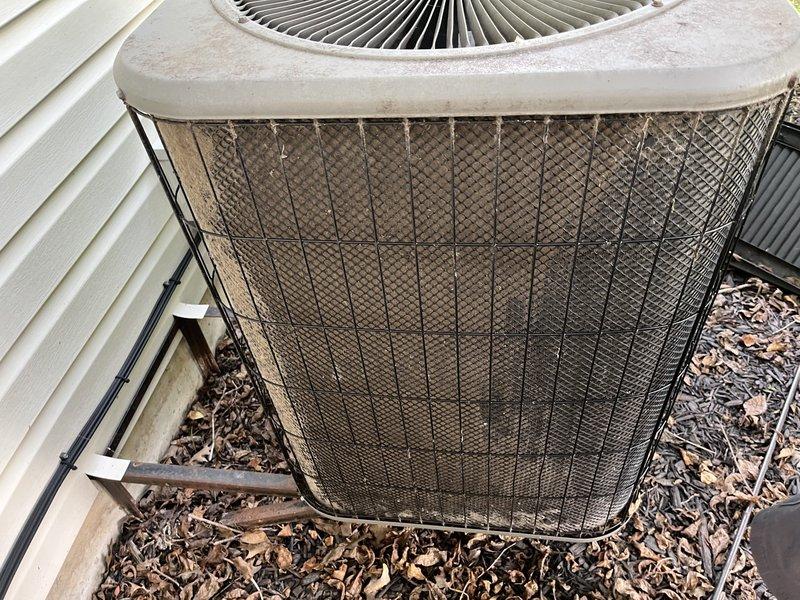 Responded to no-cool call on 10-year-old upstairs AC system. Upon arrival, found outdoor condenser unit with heavily soiled mesh guard and significant debris accumulation restricting airflow. Performed thorough cleaning of condenser coils and protective mesh guard, removed accumulated dirt, dust, and organic debris from unit exterior and surrounding area. Verified proper airflow restoration, checked refrigerant pressures, and tested system operation. Unit returned to normal cooling function with adequate airflow through condenser. Recommended regular maintenance to prevent future airflow restrictions.