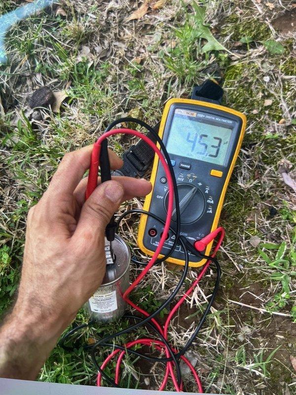 Responded to cooling complaint where system was blowing cool air but not achieving desired temperature. Performed comprehensive cooling diagnostic and discovered failed capacitor on outdoor condensing unit. Field tested capacitor with multimeter, confirming readings of 453 MFD and 122 MFD on respective terminals, both significantly outside manufacturer specifications. Replaced defective dual-run capacitor to restore proper compressor and condenser fan motor operation, returning system to normal cooling capacity.